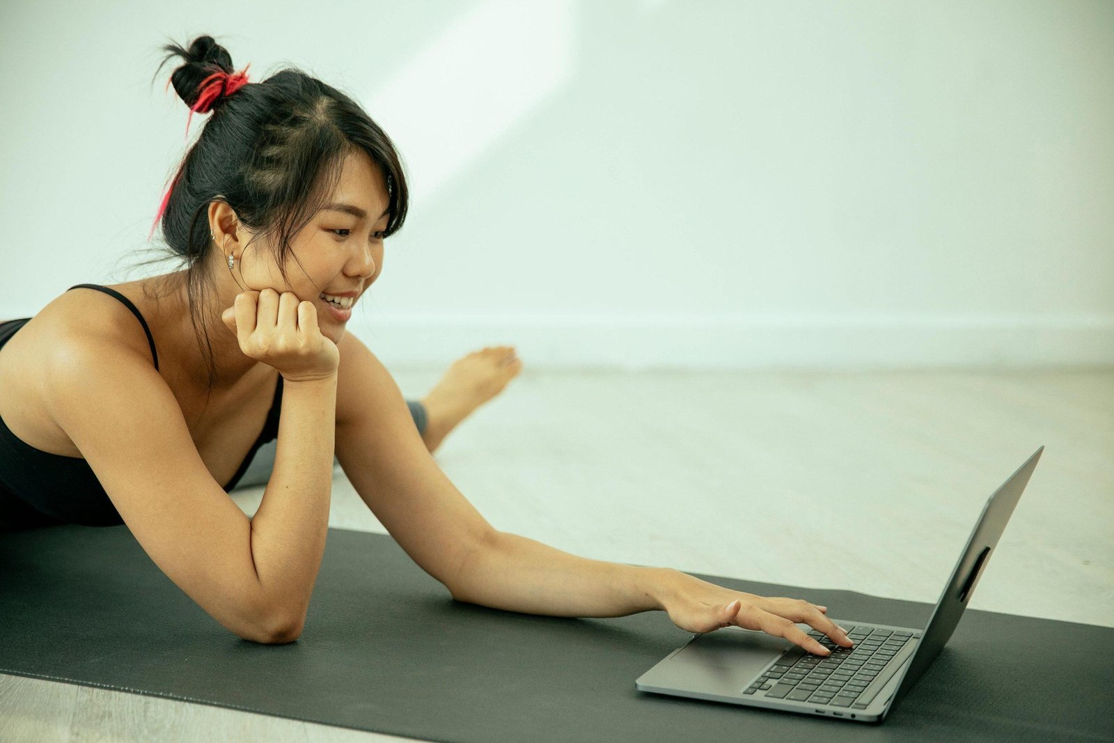 A messy bun falling apart mid-yoga session, illustrating challenges faced when using rigid hairstyles during exercise.