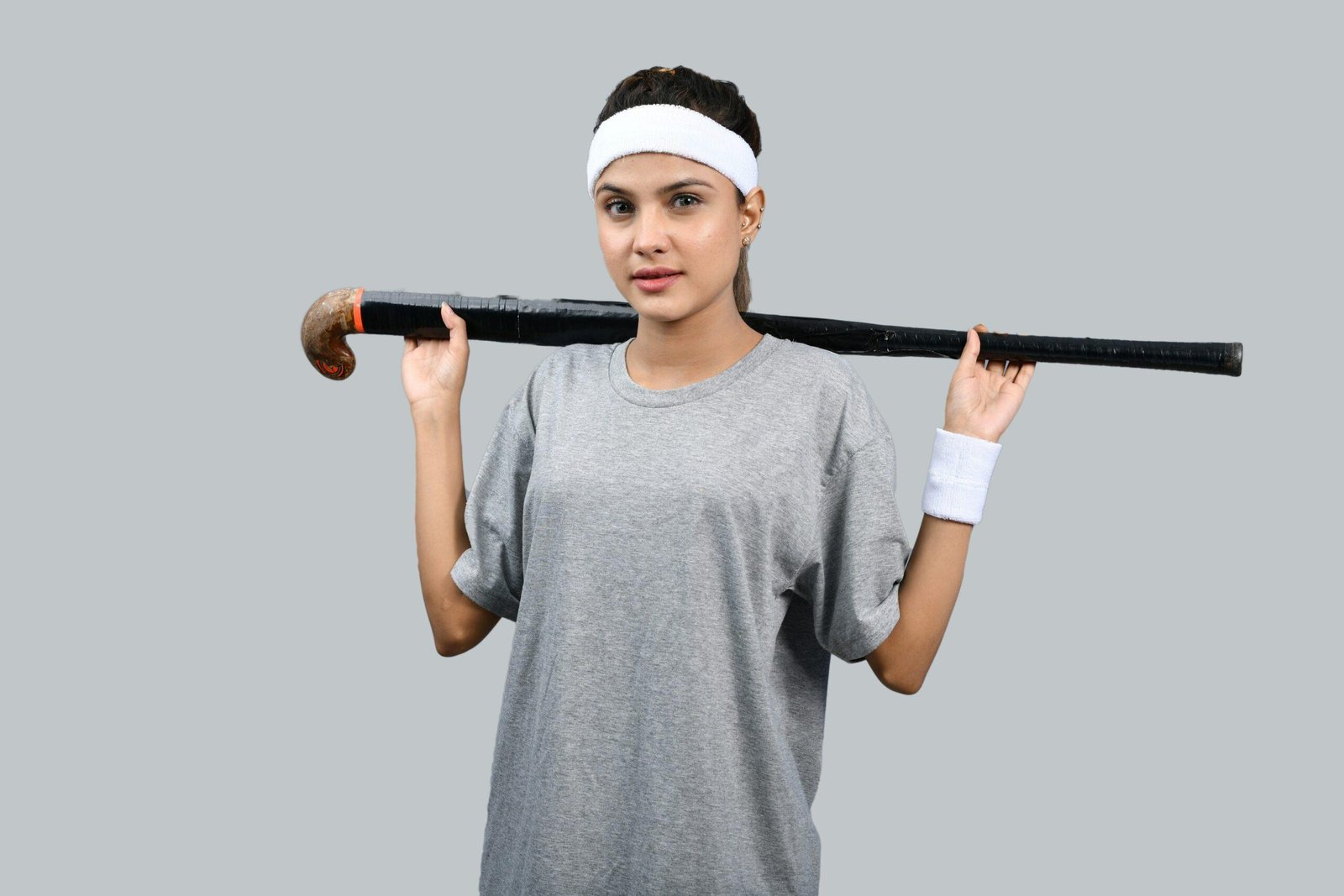 A woman looking stressed after her workout, showing signs of frizz and loose strands.
