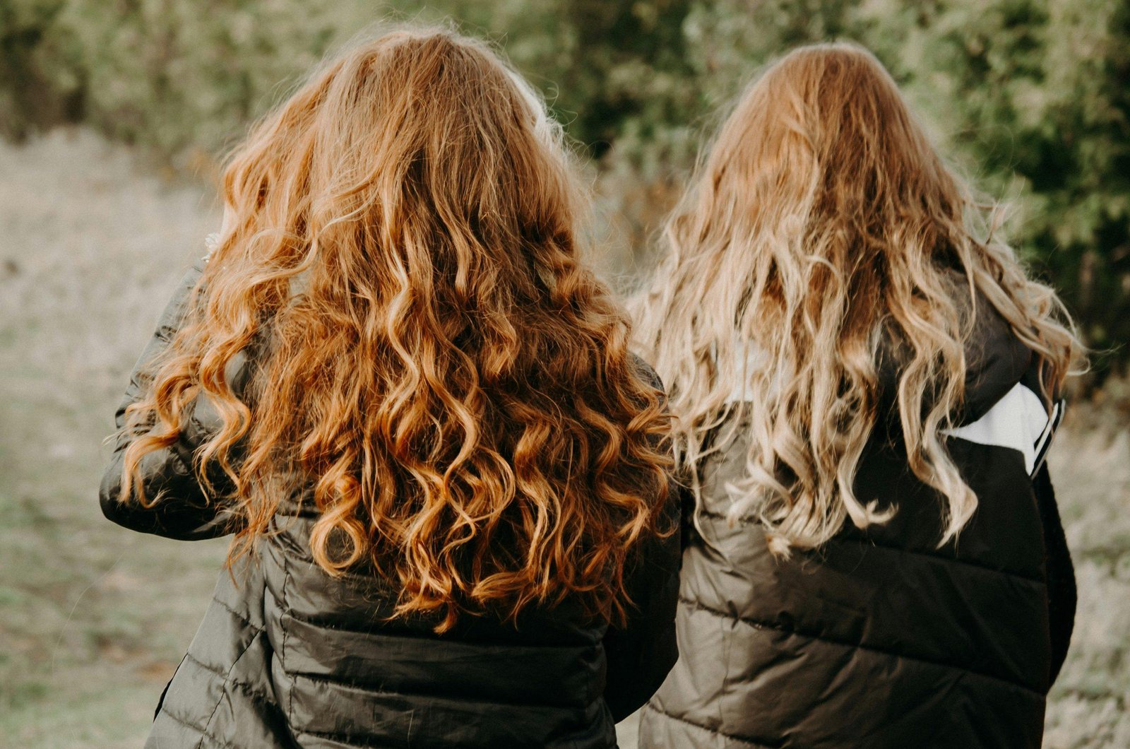 Two women showing their flawless hairstyles after working out