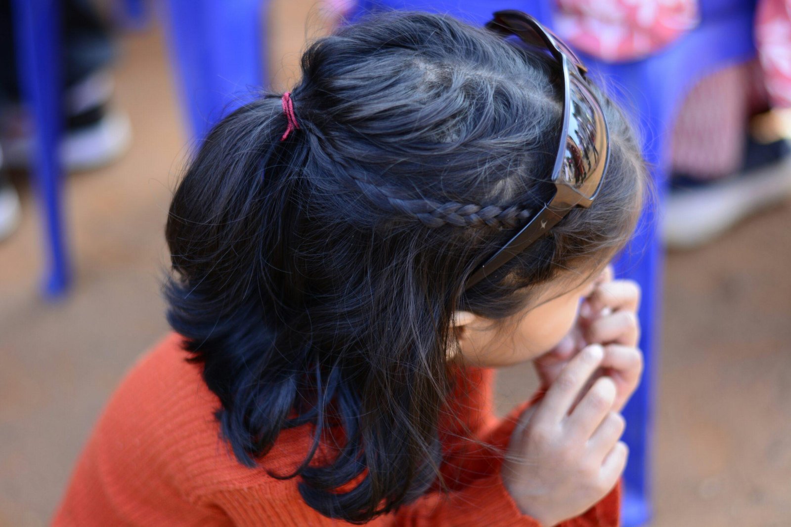 Woman struggling with messy hair during yoga session outdoors