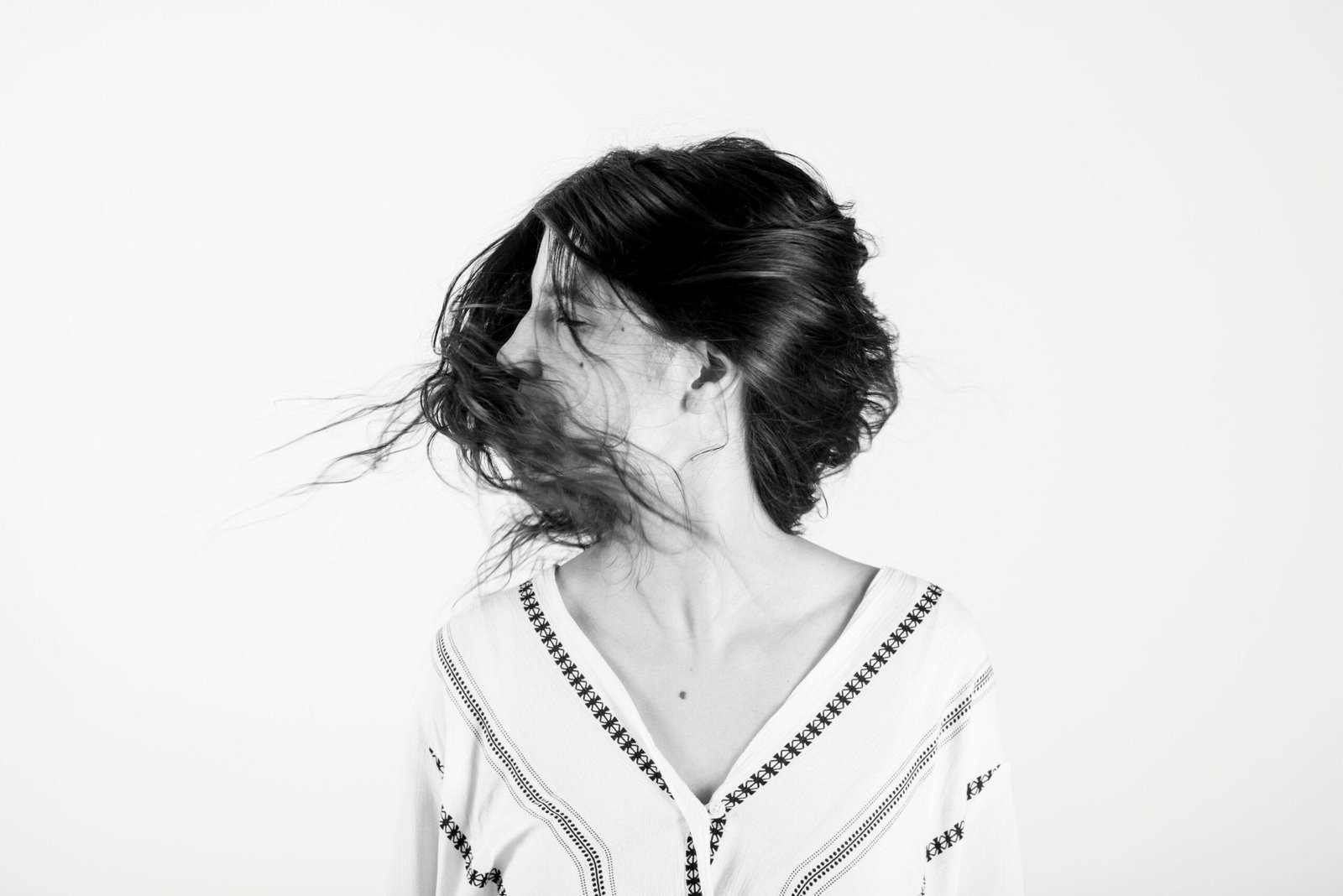 A female jogger with perfectly styled hair despite physical activity.