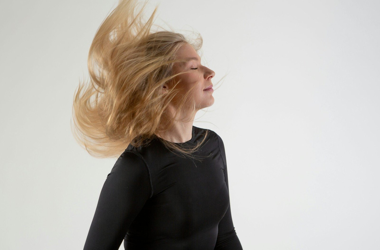 A woman practicing hair yoga techniques with calm breathing exercises