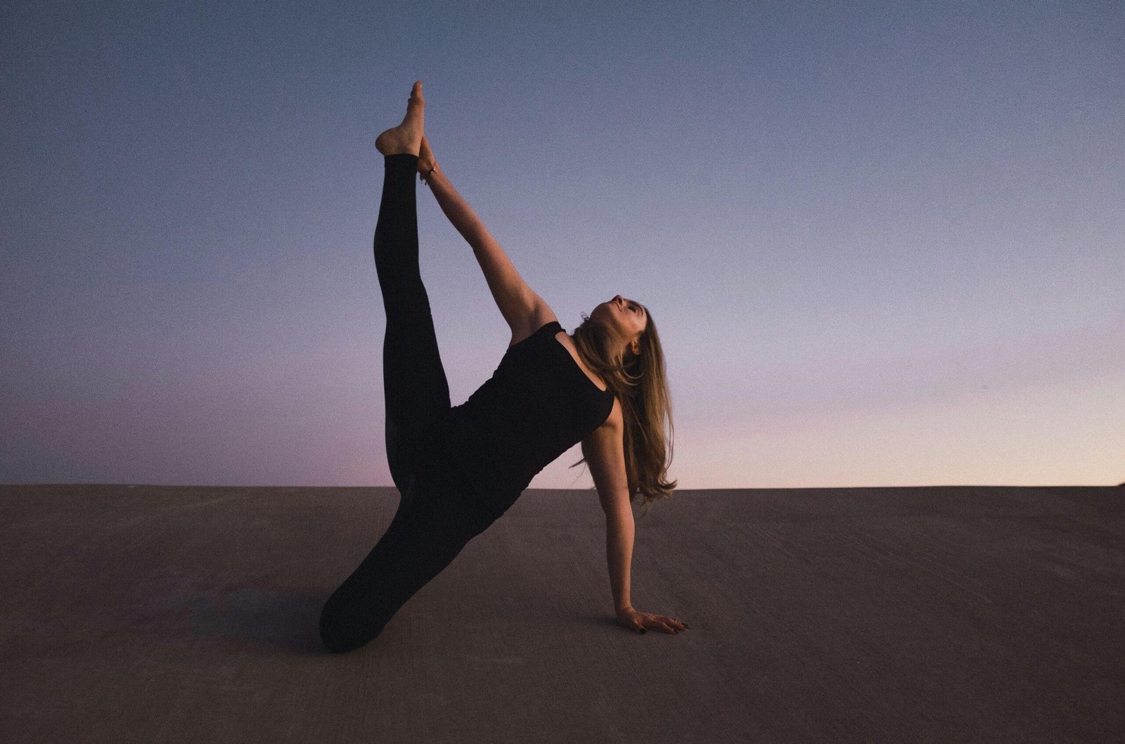 Woman with loose hair blowing back during yoga pose