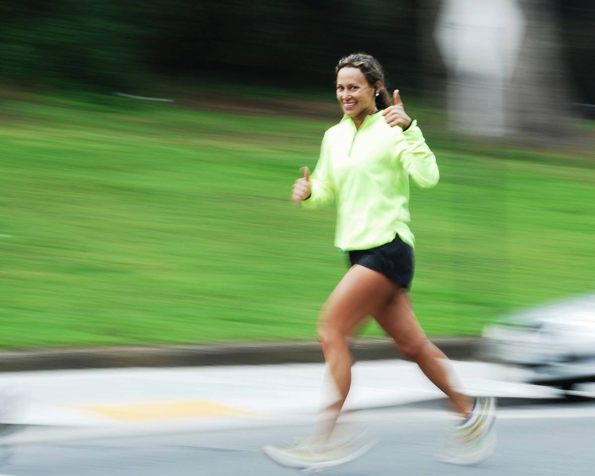 Runner smiling confidently with perfectly styled running ponytail