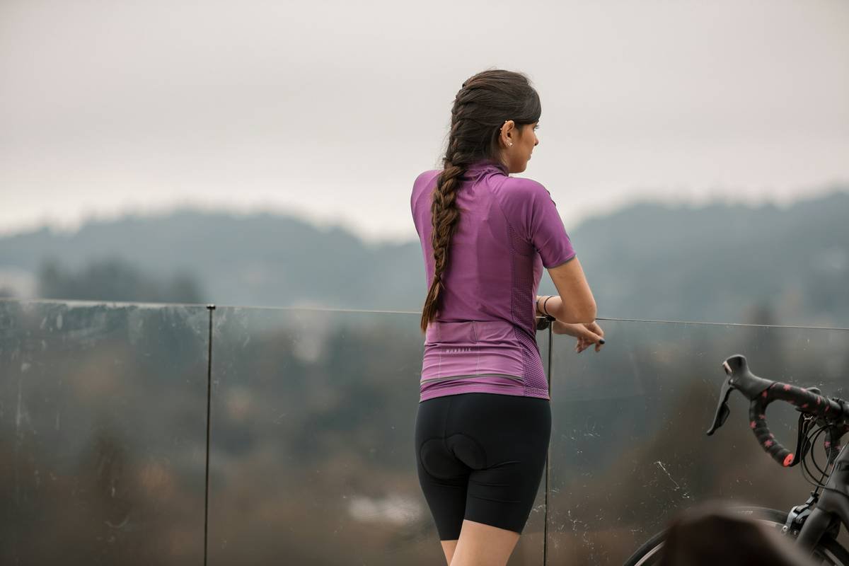 Woman jogging frustrated with messy ponytail in wind