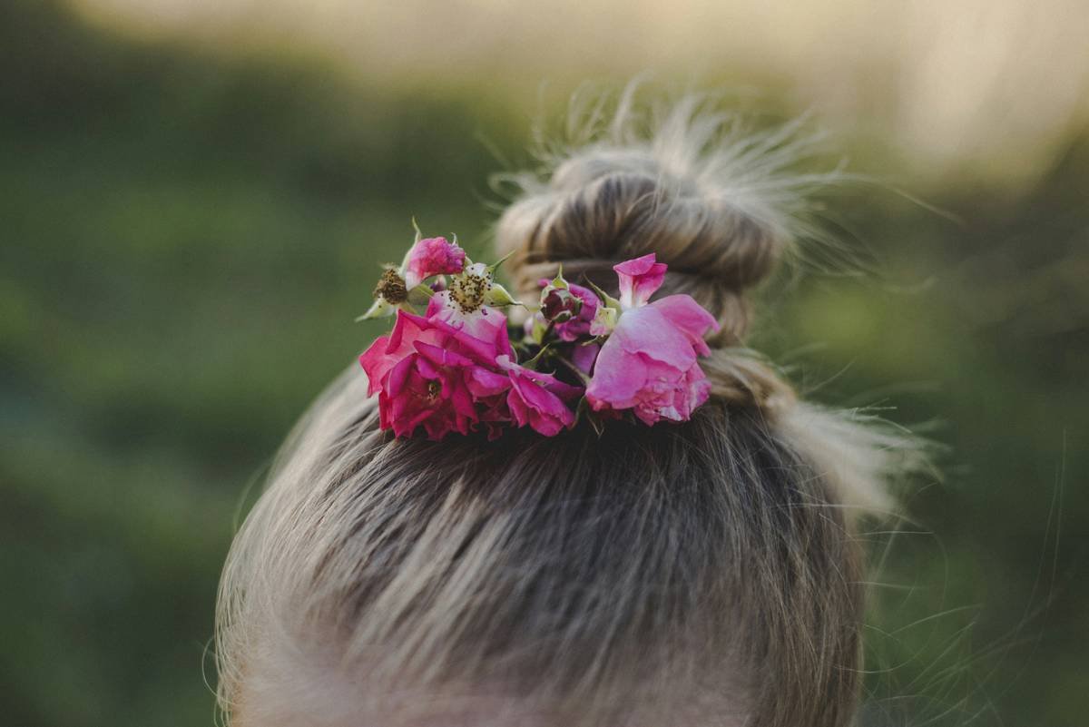 Woman practicing hair yoga technique at home.
