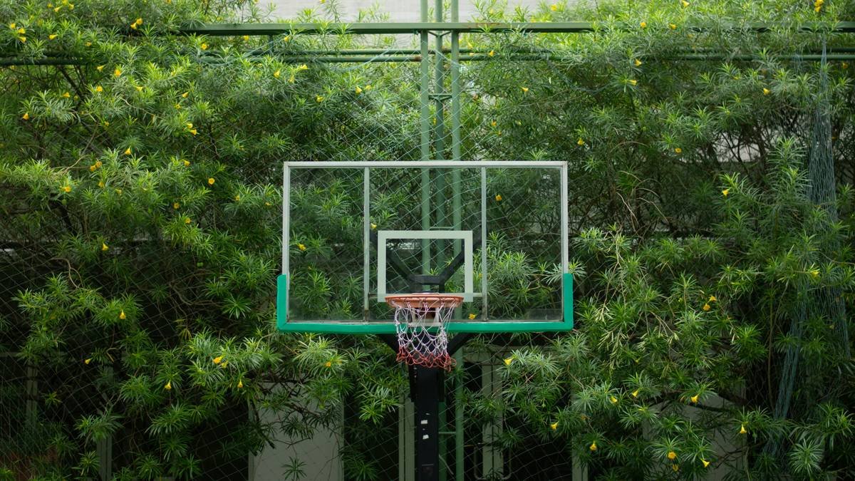 Woman practicing yoga outdoors wearing a chic messy bun.