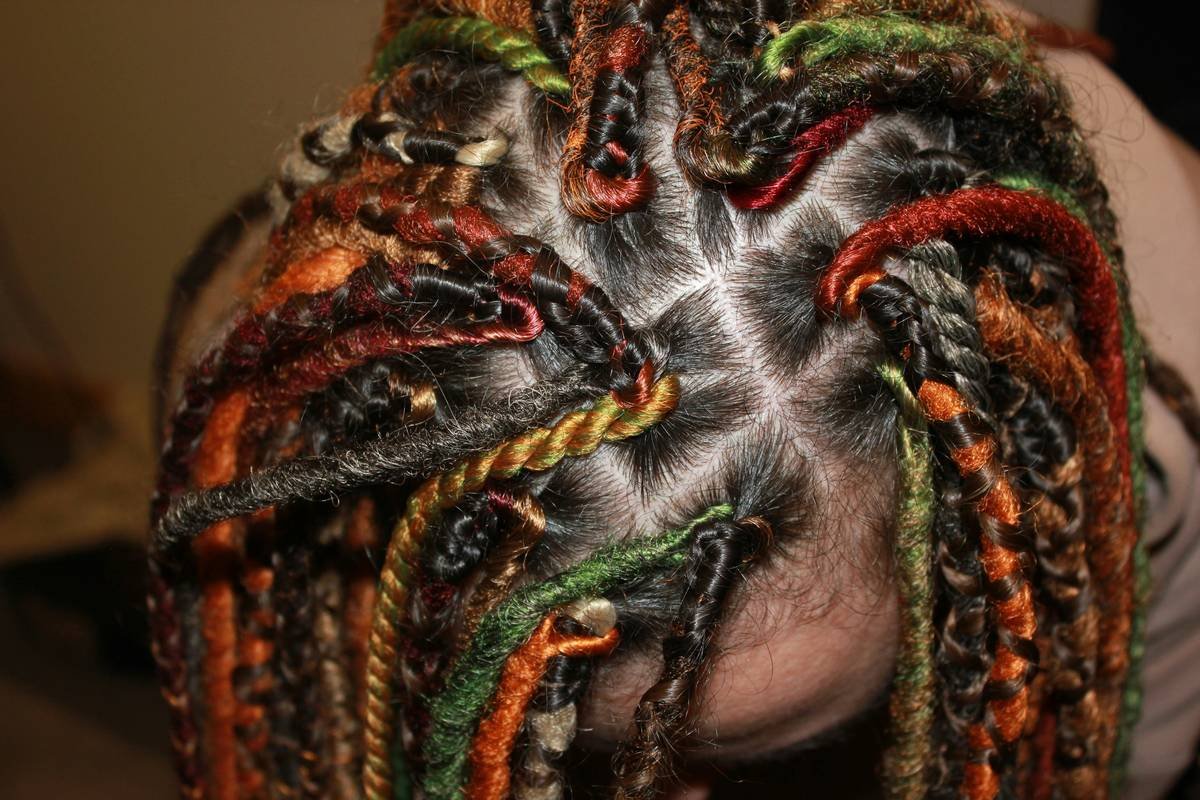 A woman demonstrating a flawless sweatproof updo secured tightly at the back