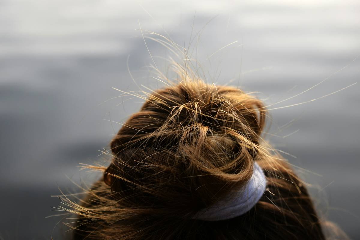 Woman struggling with her hair during pilates workout