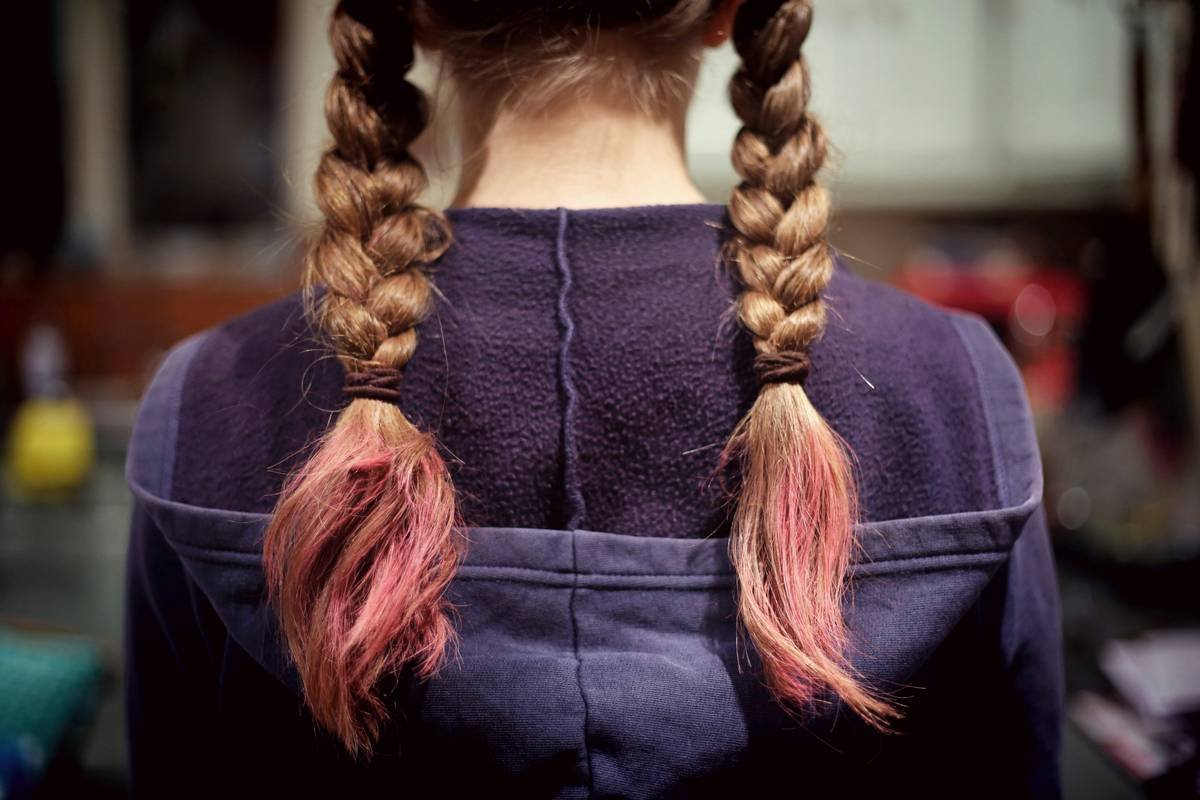 Diagram showing tension points on scalp during high bun vs. low twisted bun during exercise