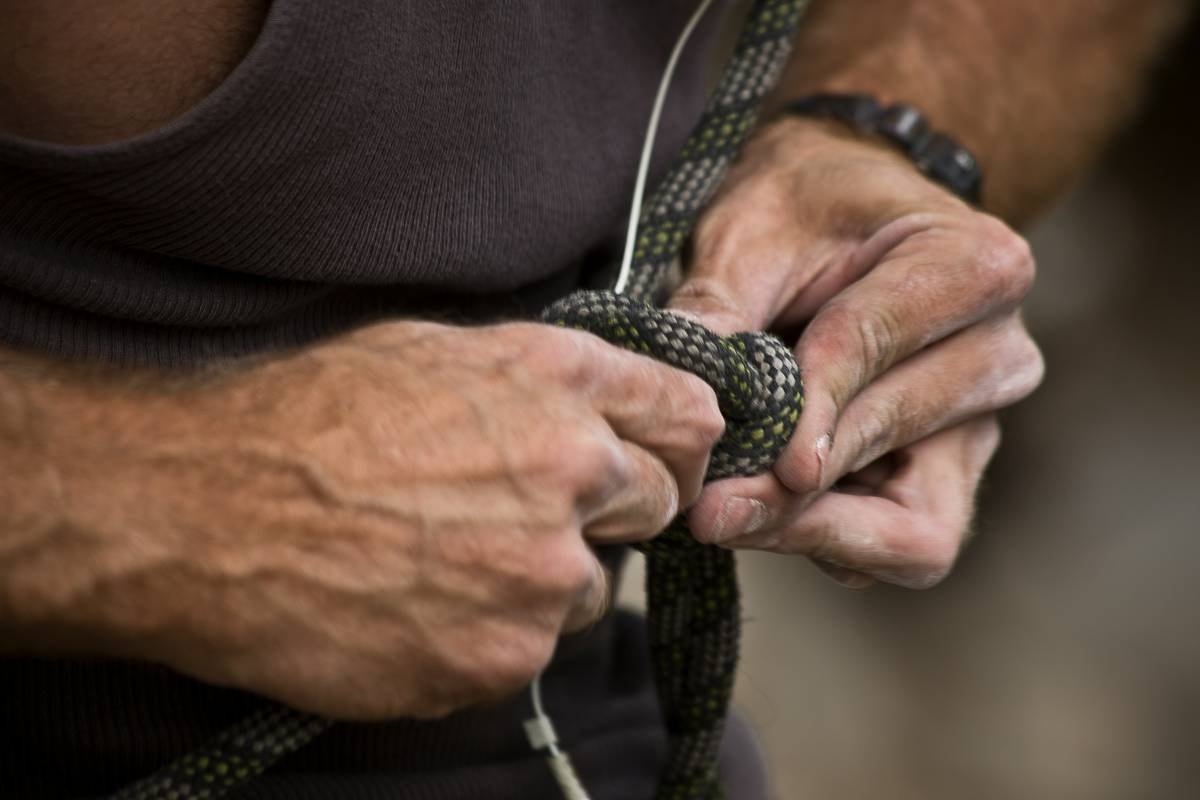 a close up of a person holding a rope