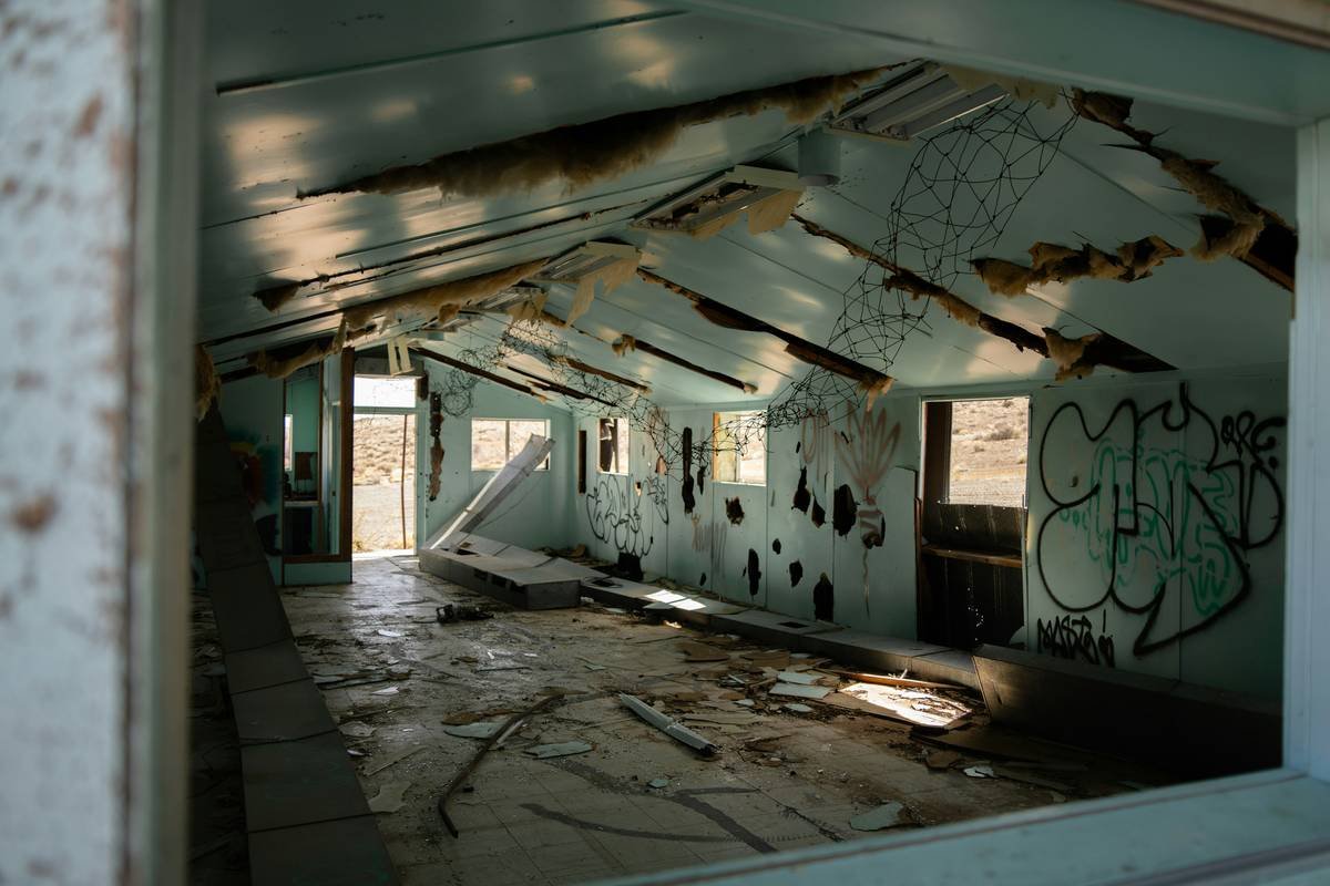 a run down building with graffiti on the walls