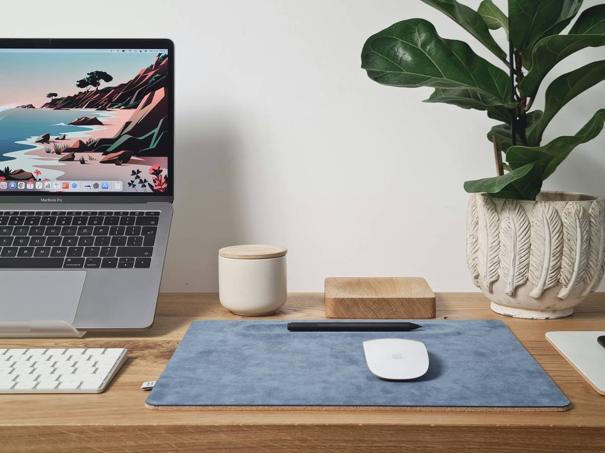 macbook pro on brown wooden table