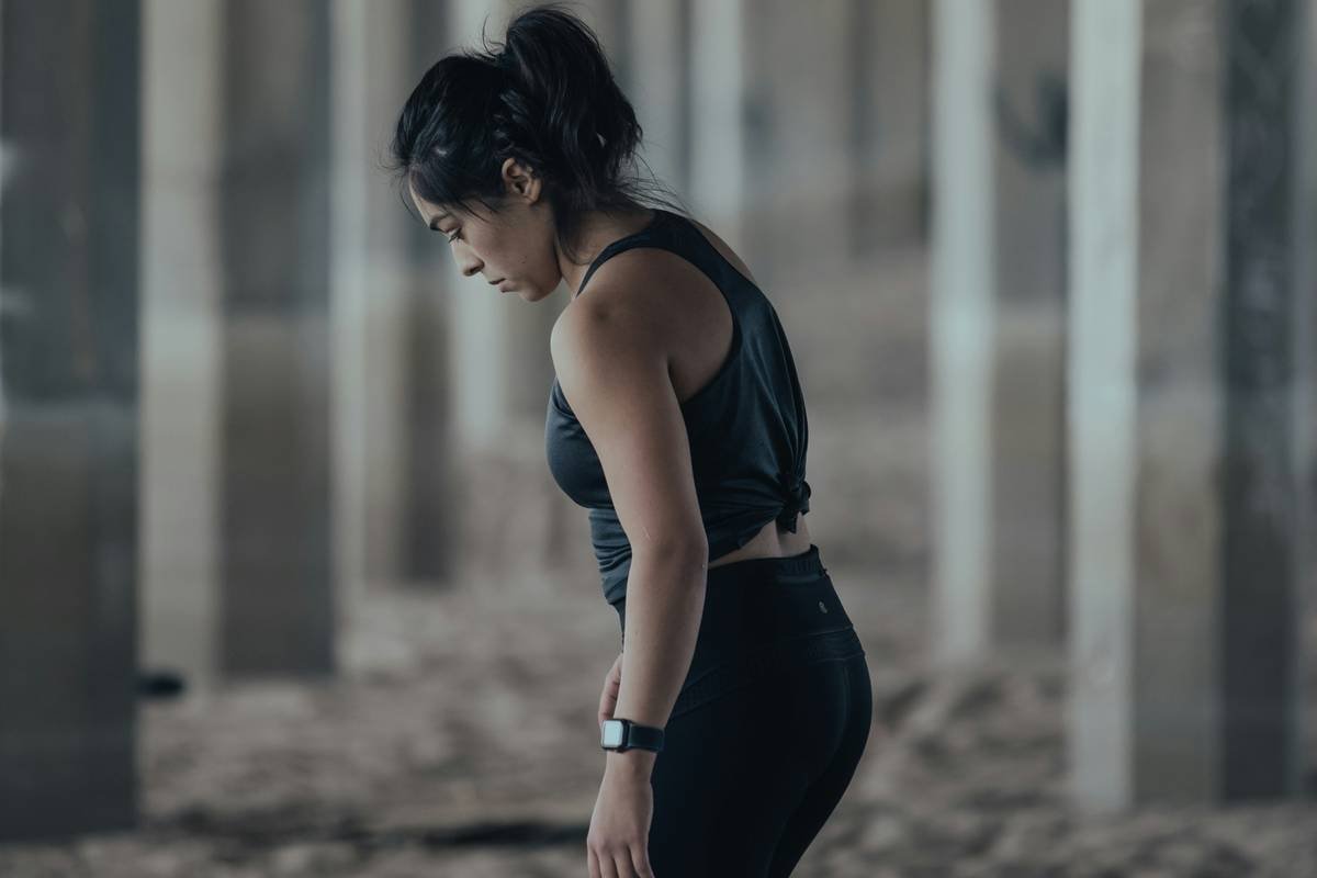 woman in blue tank top and black leggings