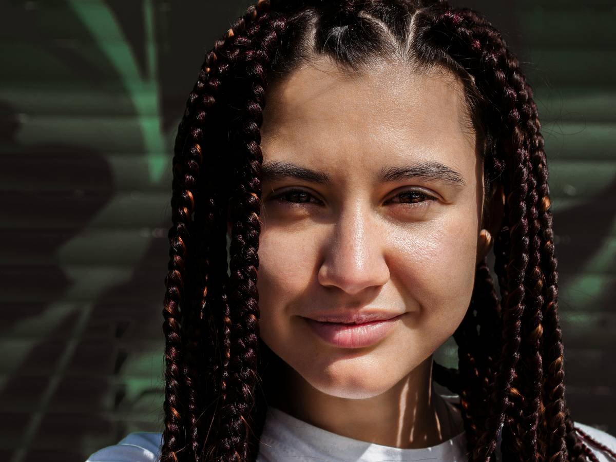woman in white shirt with braided hair