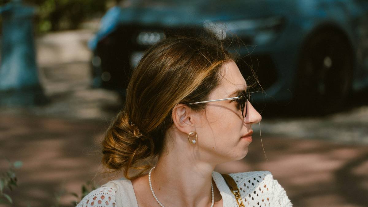 Woman with sunglasses looking away from camera.